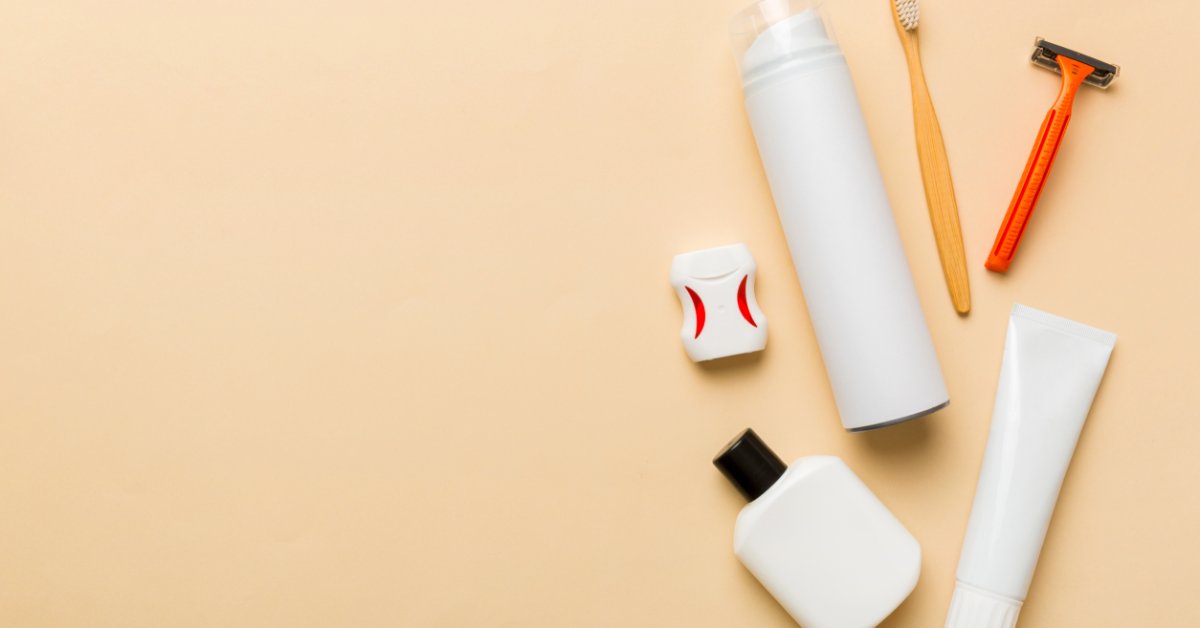 A collection of hygiene products, including a toothbrush, razor, dental floss, and three unmarked items.